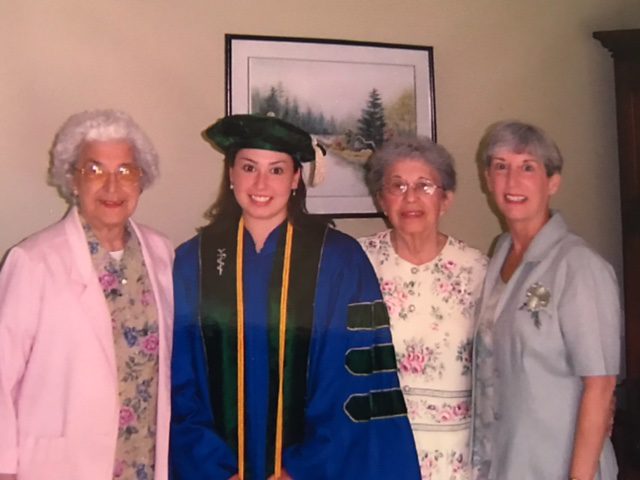 Dr. Malone (center) graduating from Medical School