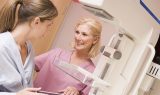 Smiling nurse helps woman receive a 3D Mammogram, available in Conway, SC.