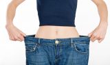 successful weight loss, woman with too large jeans after choosing the right type of bariatric surgery