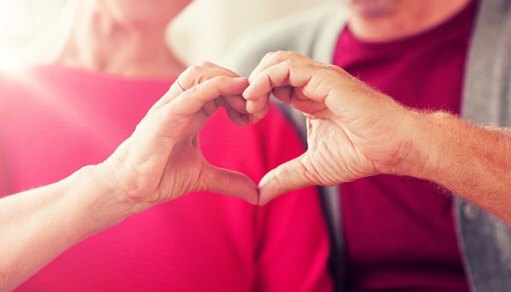 Elderly couple making a heart with their hands heart health tips