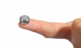 Closeup of a button battery on a finger button battery ingestion