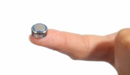 Closeup of a button battery on a finger button battery ingestion