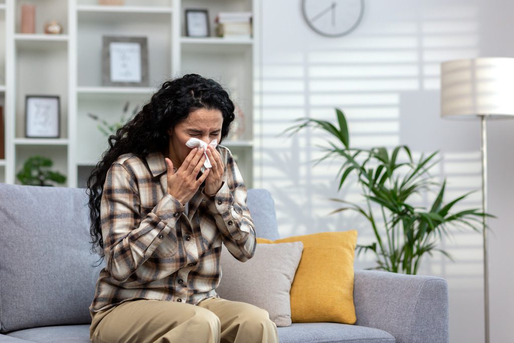 A Woman Sneezing Due to Bad Ragweed Allergies