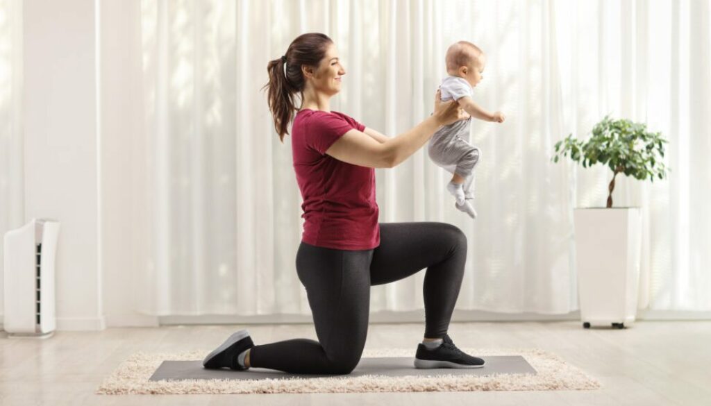 Smiling woman lunging while holding her baby trying to lose weight after pregnancy