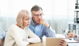 An older couple looking at test results being shown by a doctor Colon Cancer Stages